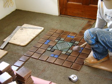 Adjusting the Pewabic tiles to accommodate their greater depth.