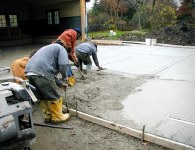 The team works fast to pour and trowel and finish the surface
