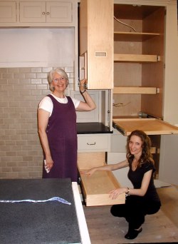 Carol sees spice rack (top) will be handy when range is installed next to pantry. Marie demonstrates pull-out below.