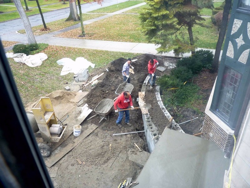 As viewed from second storey, trench footers filled with soil and gravel. Conduit in place