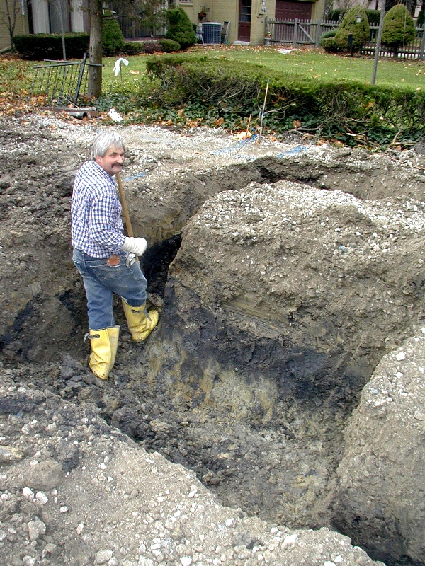 Jack cleans up area for pouring garage footers.